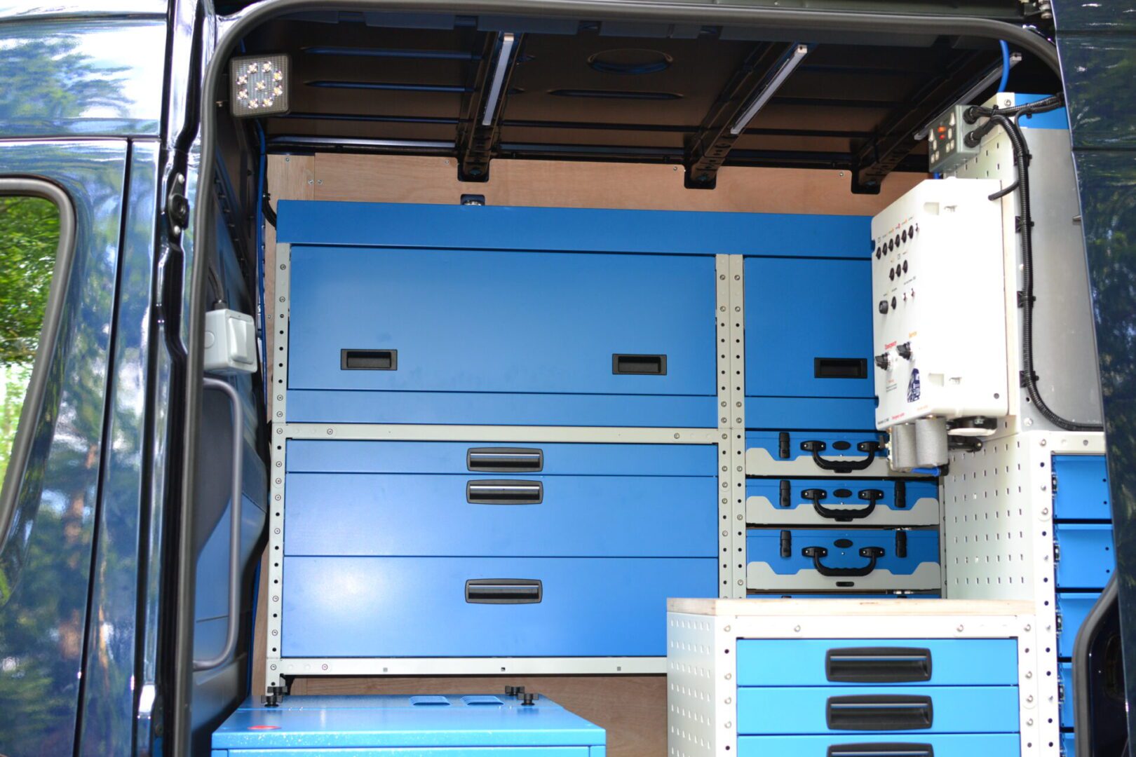 Side door racking view in a Mercedes sprinter van for recovery business